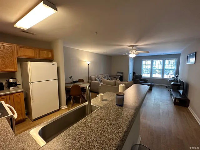 a view of a living room hardwood floor and a window