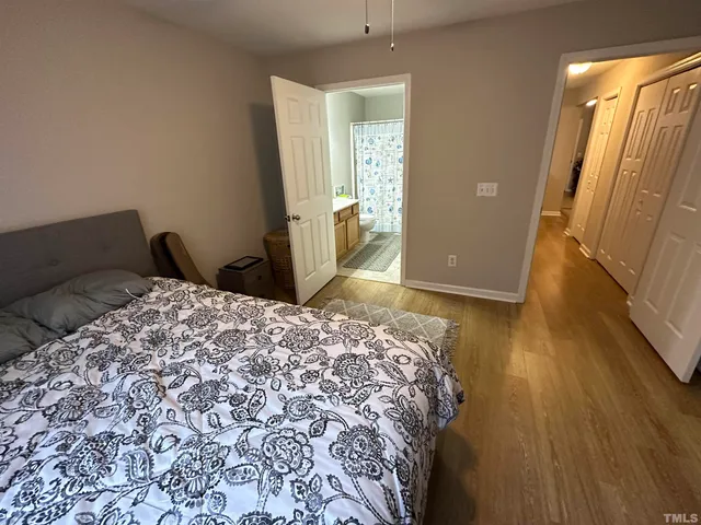 a bathroom with a sink a toilet a mirror and shower curtain