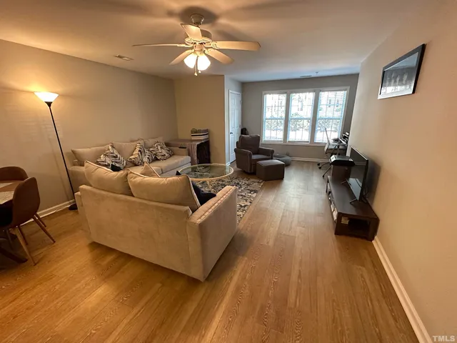 a living room with couches and a flat screen tv