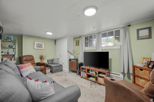 1275 North Geneva Road Provo, UT 84601 - Photo 12 of 25 Spacious living area featuring light green walls and light-colored flooring