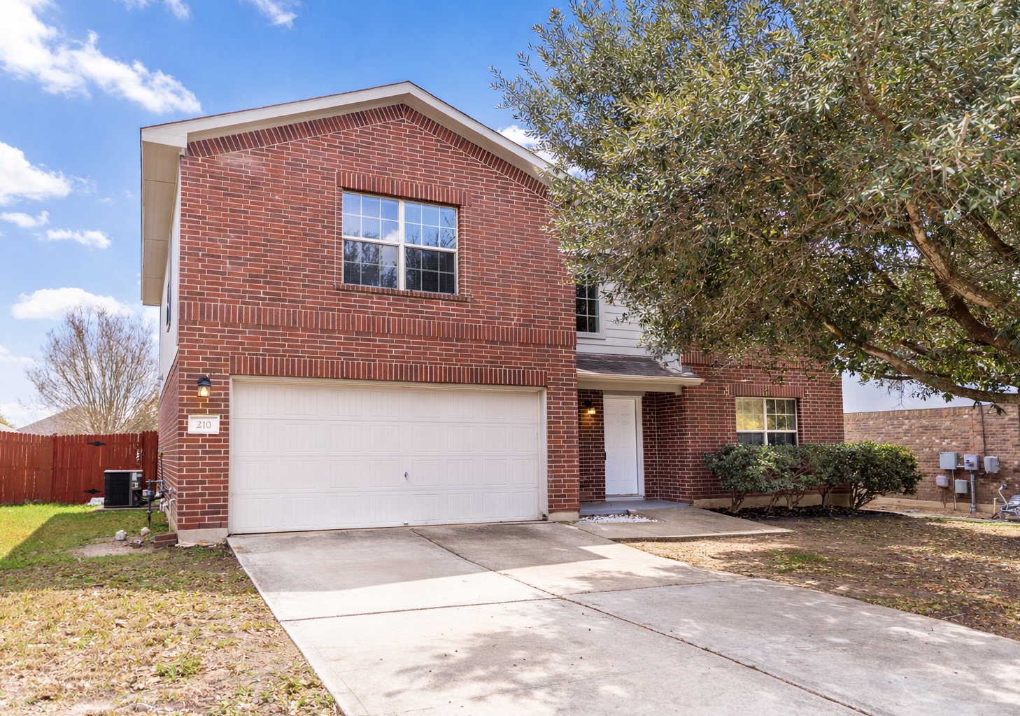 210 King Ridge Drive Buda, TX 78610 - Photo 1 of 29 Traditional-style house featuring brick siding, concrete driveway, and a garage