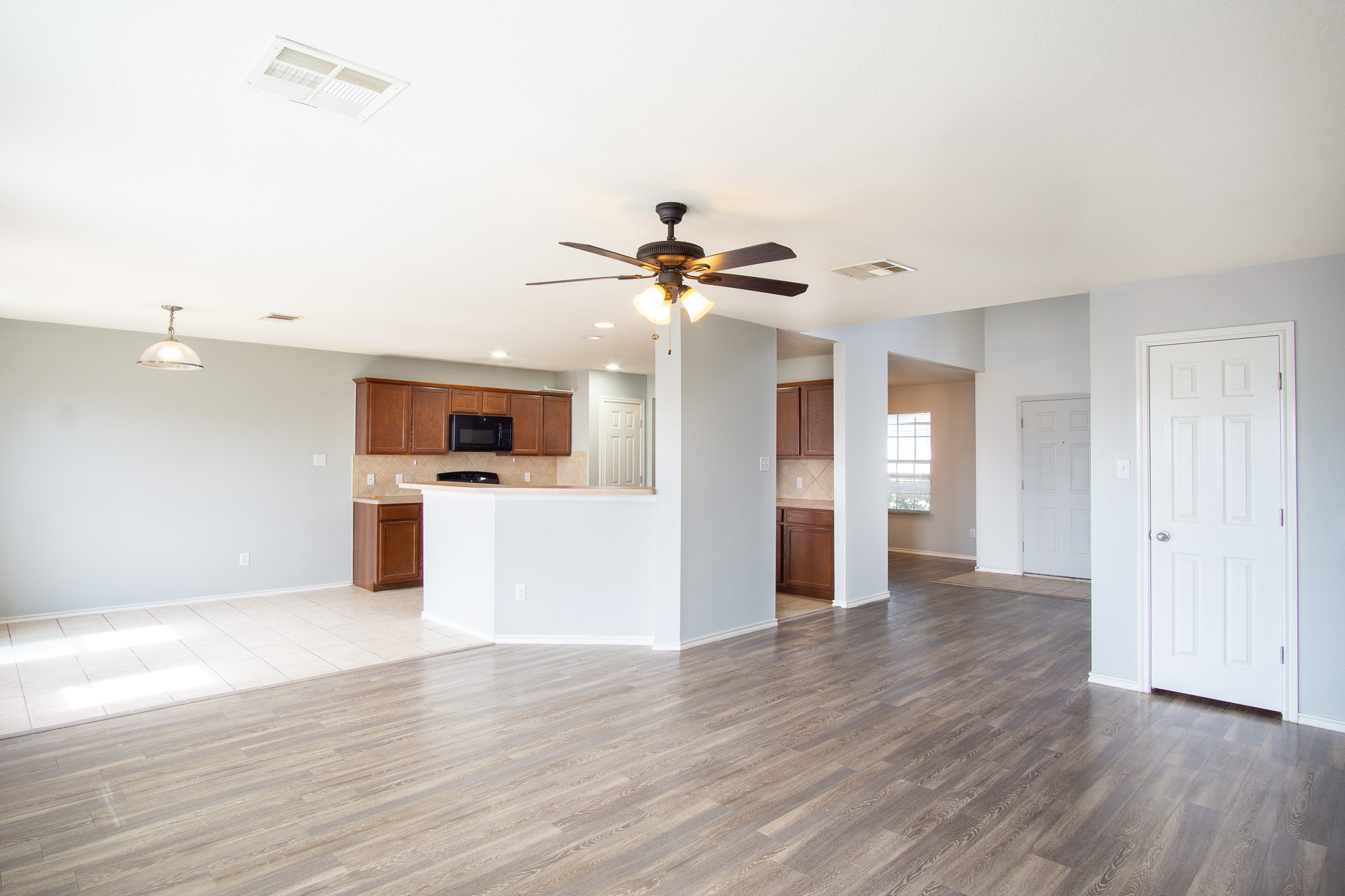 210 King Ridge Drive Buda, TX 78610 - Photo 3 of 29 Unfurnished living room with a ceiling fan, dark wood-type flooring, and recessed lighting