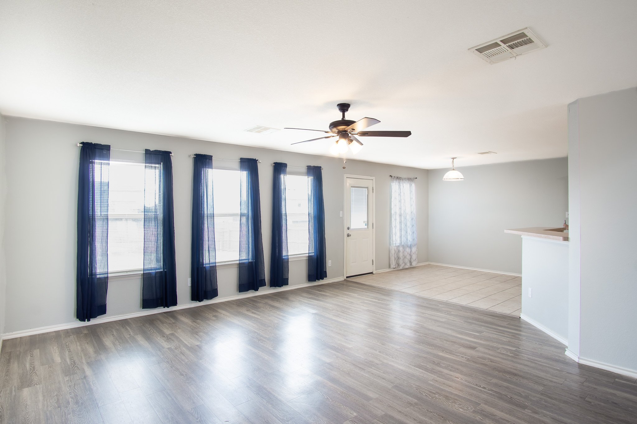 210 King Ridge Drive Buda, TX 78610 - Photo 5 of 29 Unfurnished room featuring ceiling fan and wood finished floors
