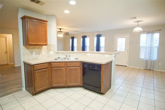 a kitchen with stainless steel appliances granite countertop a sink and dishwasher with a granite countertops