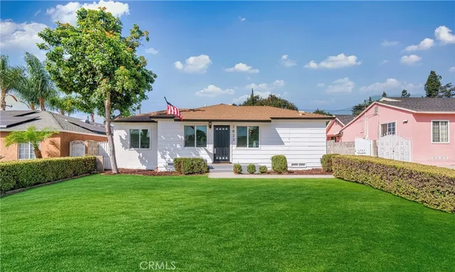a front view of a house with a garden and porch