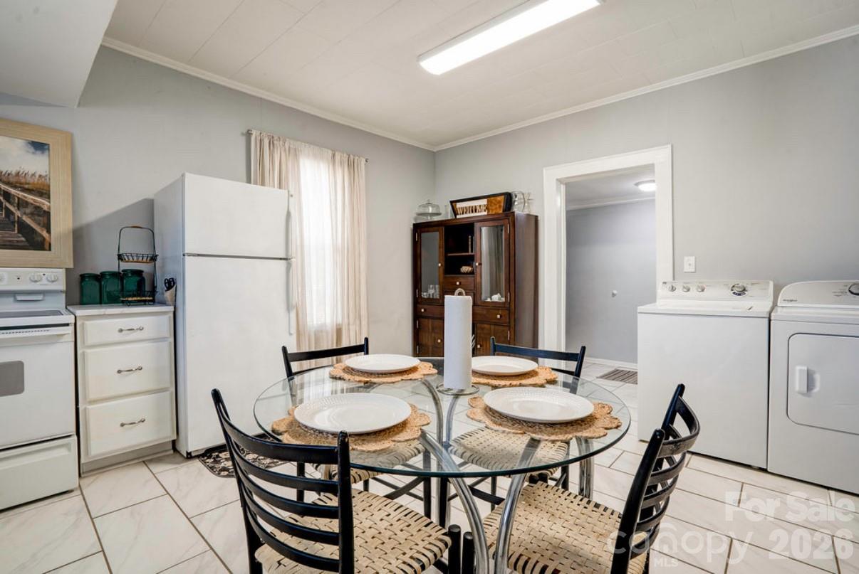 403 Whitener Street Shelby, NC 28152 - Photo 15 of 29 a kitchen with a dining table chairs and refrigerator