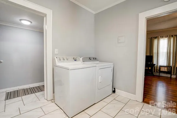 a utility room with cabinets washer and dryer
