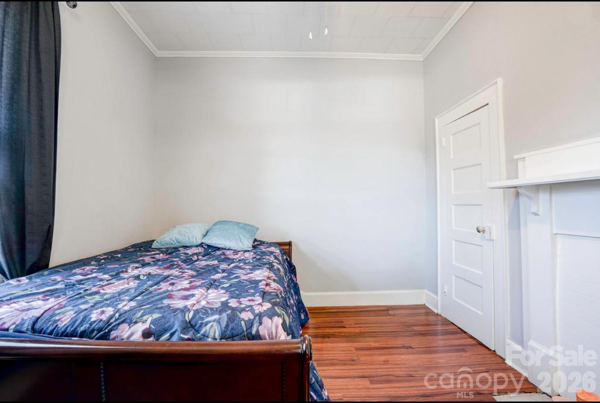 403 Whitener Street Shelby, NC 28152 - Photo 26 of 29 a bedroom with a bed and wooden floor