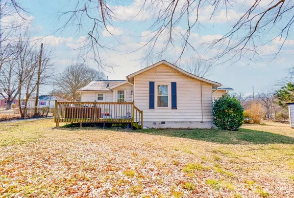 a view of a house with a yard covered with snow