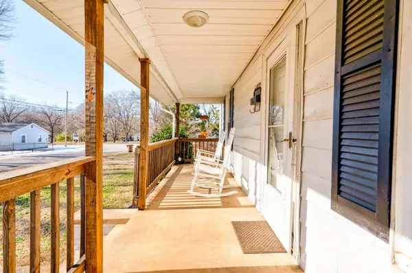 a view of balcony with wooden floor and furniture