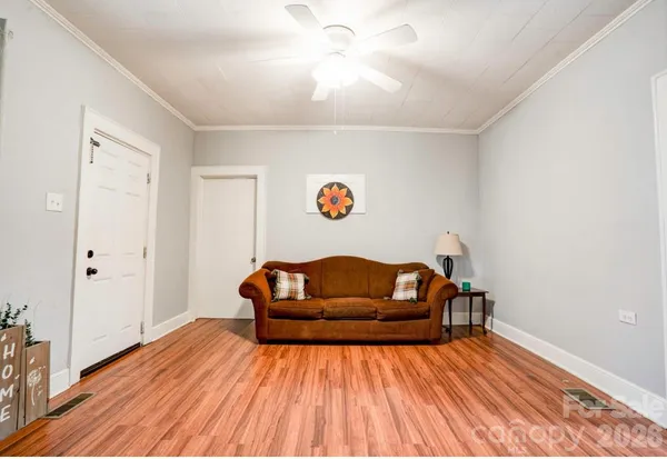 a living room with furniture and wooden floor