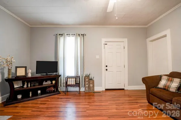 a view of a livingroom with furniture and a flat screen tv