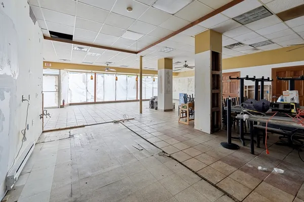 a kitchen with granite countertop a refrigerator oven a sink dishwasher and white cabinets with wooden floor