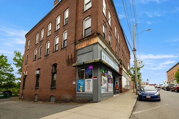 a view of a building with car parked