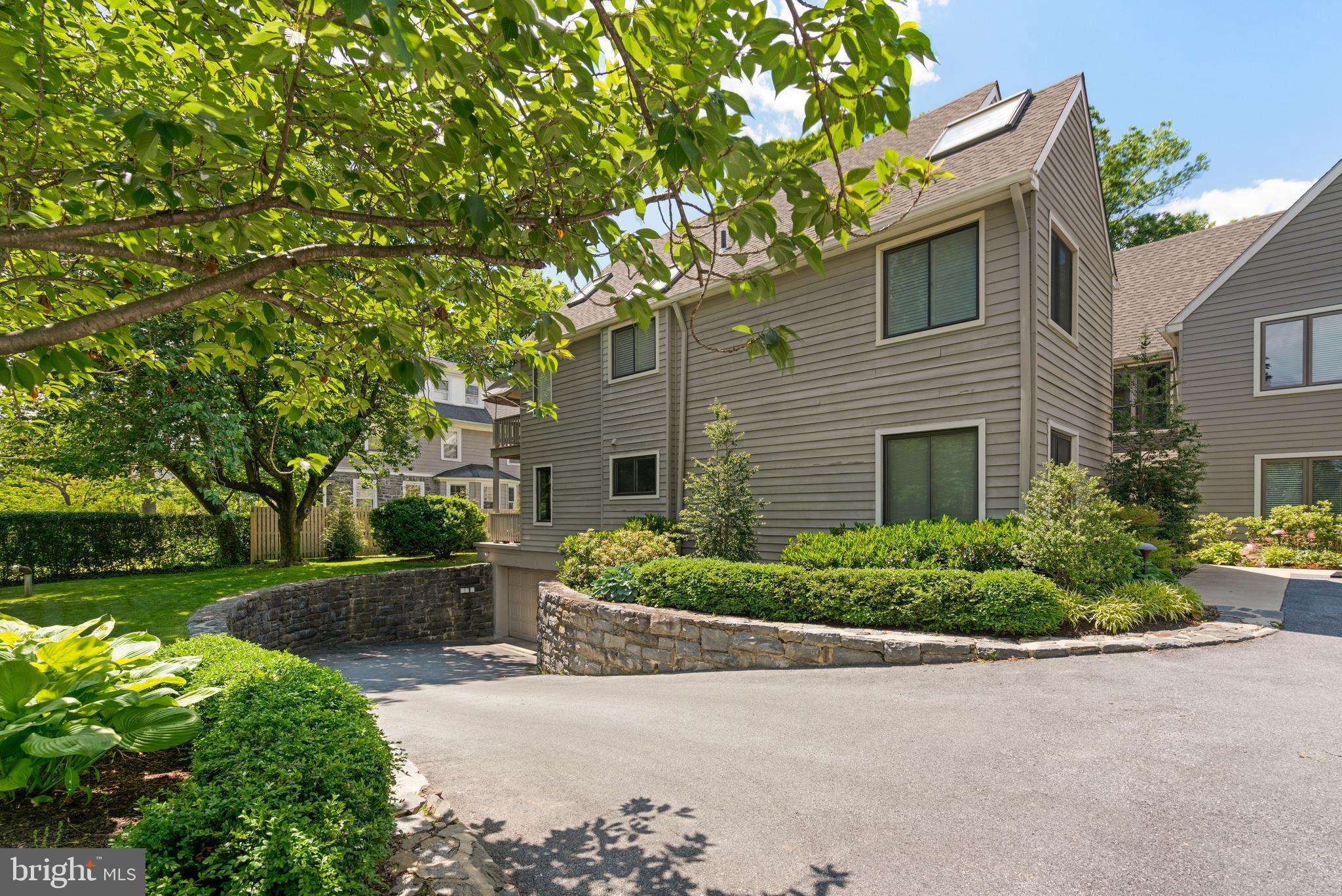 232 Church Road, Unit 3B Ardmore, PA 19003 - Photo 17 of 18 a front view of a house with a yard and trees