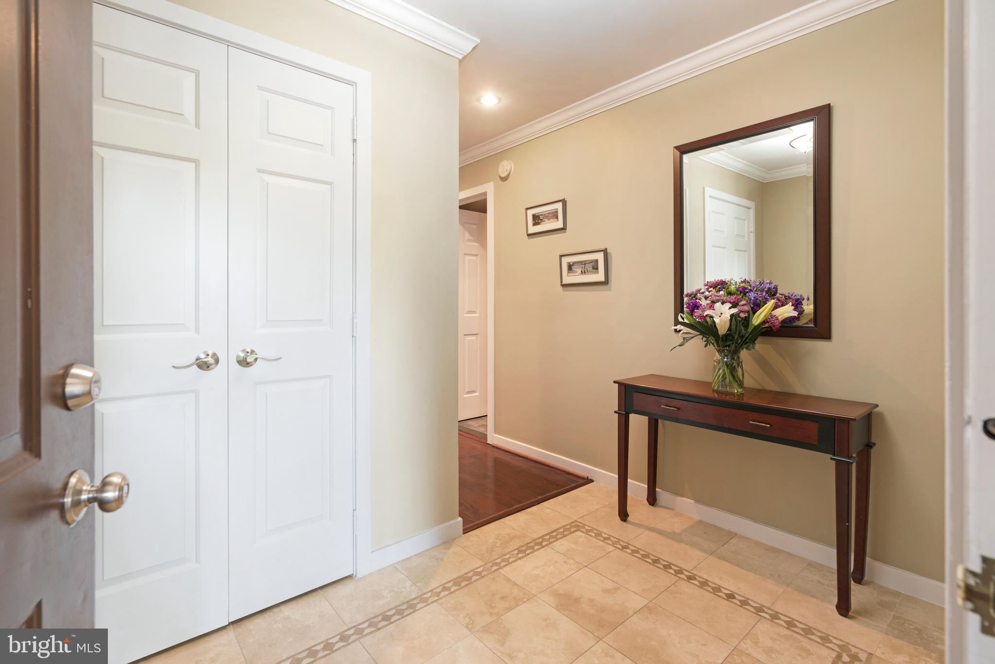 232 Church Road, Unit 3B Ardmore, PA 19003 - Photo 3 of 18 a view of a hallway with a flower pot and a bookshelf