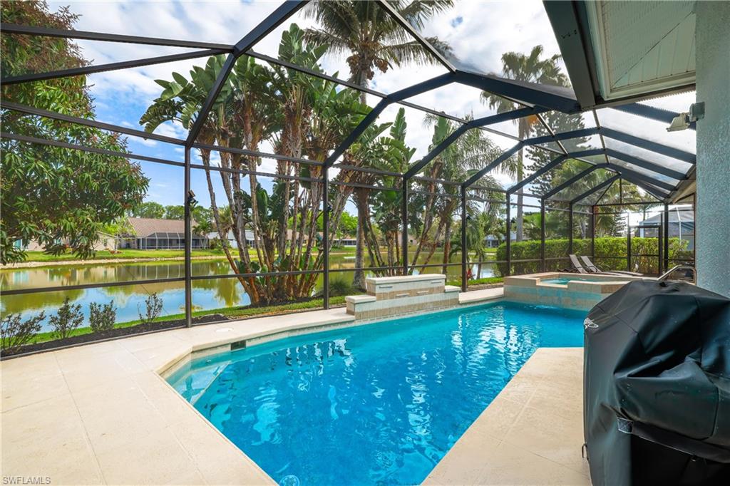 5235 Malvern Court Naples, FL 34112 - Photo 4 of 28 a view of a swimming pool with a patio