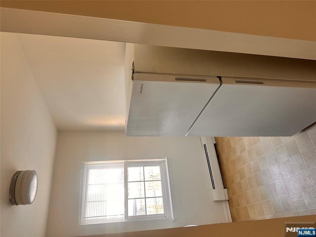 278 Main Street, Unit E3 Little Ferry, NJ 07643 - Photo 2 of 6 a view of an empty room with a window