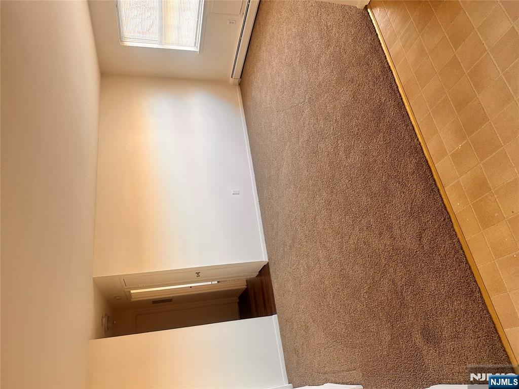 278 Main Street, Unit E3 Little Ferry, NJ 07643 - Photo 4 of 6 a view of an empty room and window