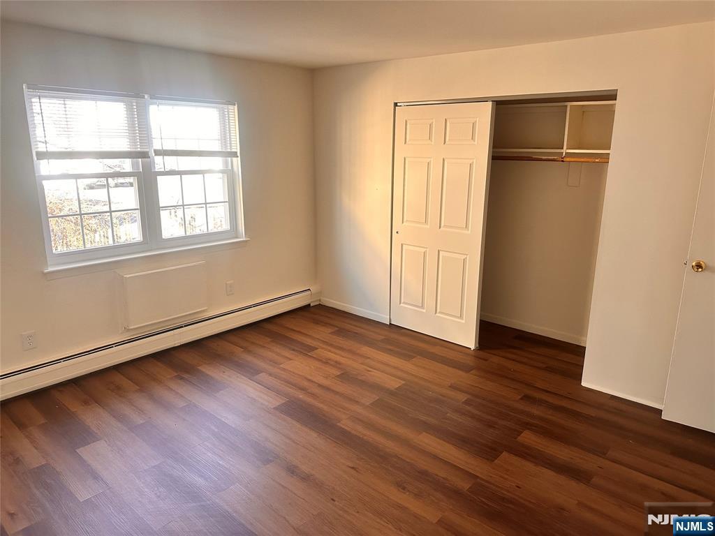 278 Main Street, Unit E3 Little Ferry, NJ 07643 - Photo 5 of 6 an empty room with wooden floor closet and windows