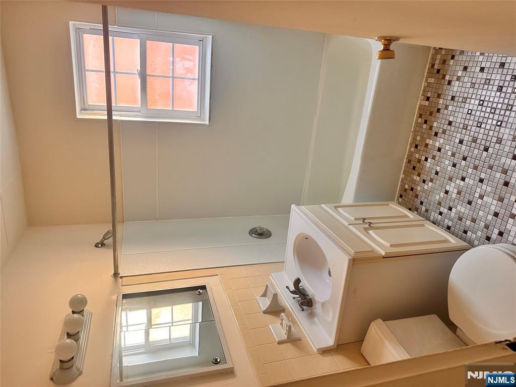 278 Main Street, Unit E3 Little Ferry, NJ 07643 - Photo 6 of 6 a bathroom with a sink a toilet and shower