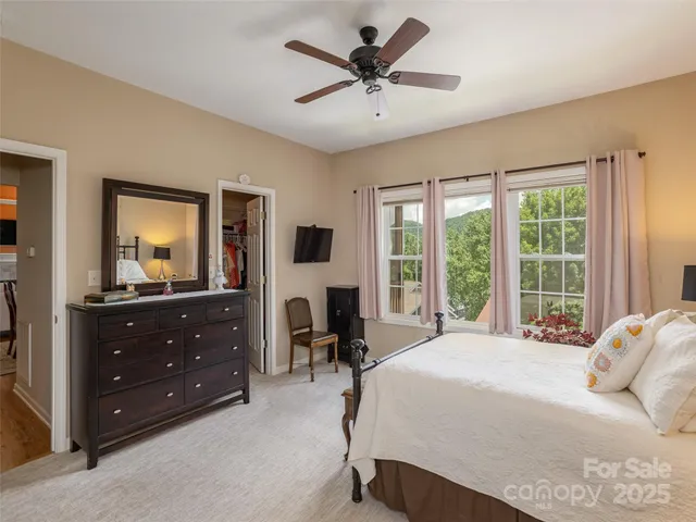 a bedroom with a bed and a mirror on dresser