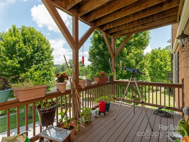 a view of a balcony with chairs and wooden floor