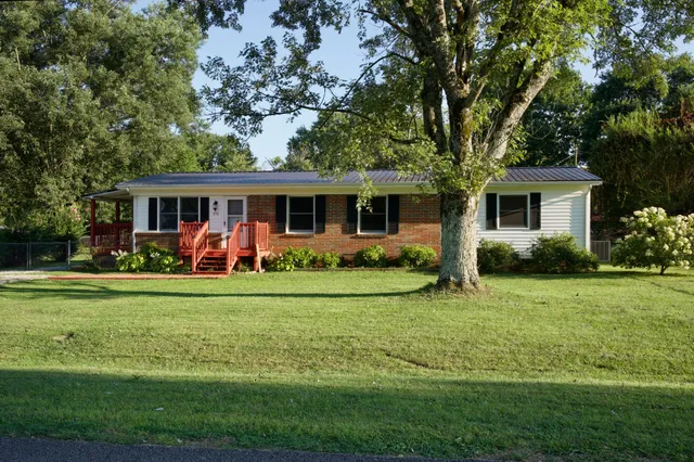 a view of a house with a backyard and a patio