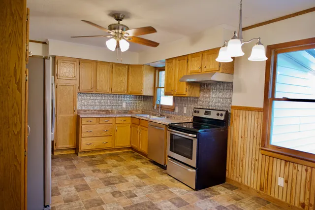 a kitchen with a stove a sink and a refrigerator