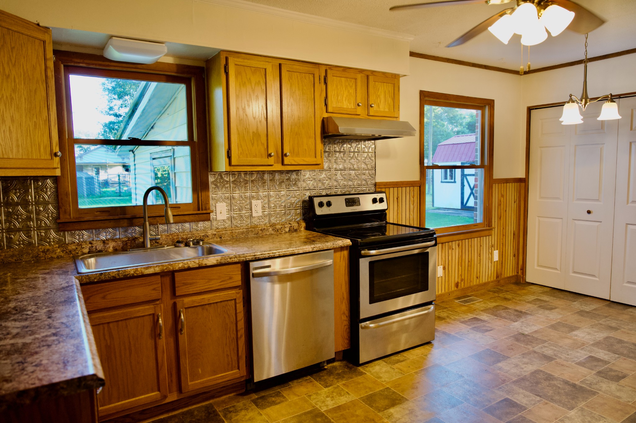 570 Forest Circle Sparta, TN 38583 - Photo 13 of 27 a kitchen with stainless steel appliances granite countertop a stove a sink and a refrigerator