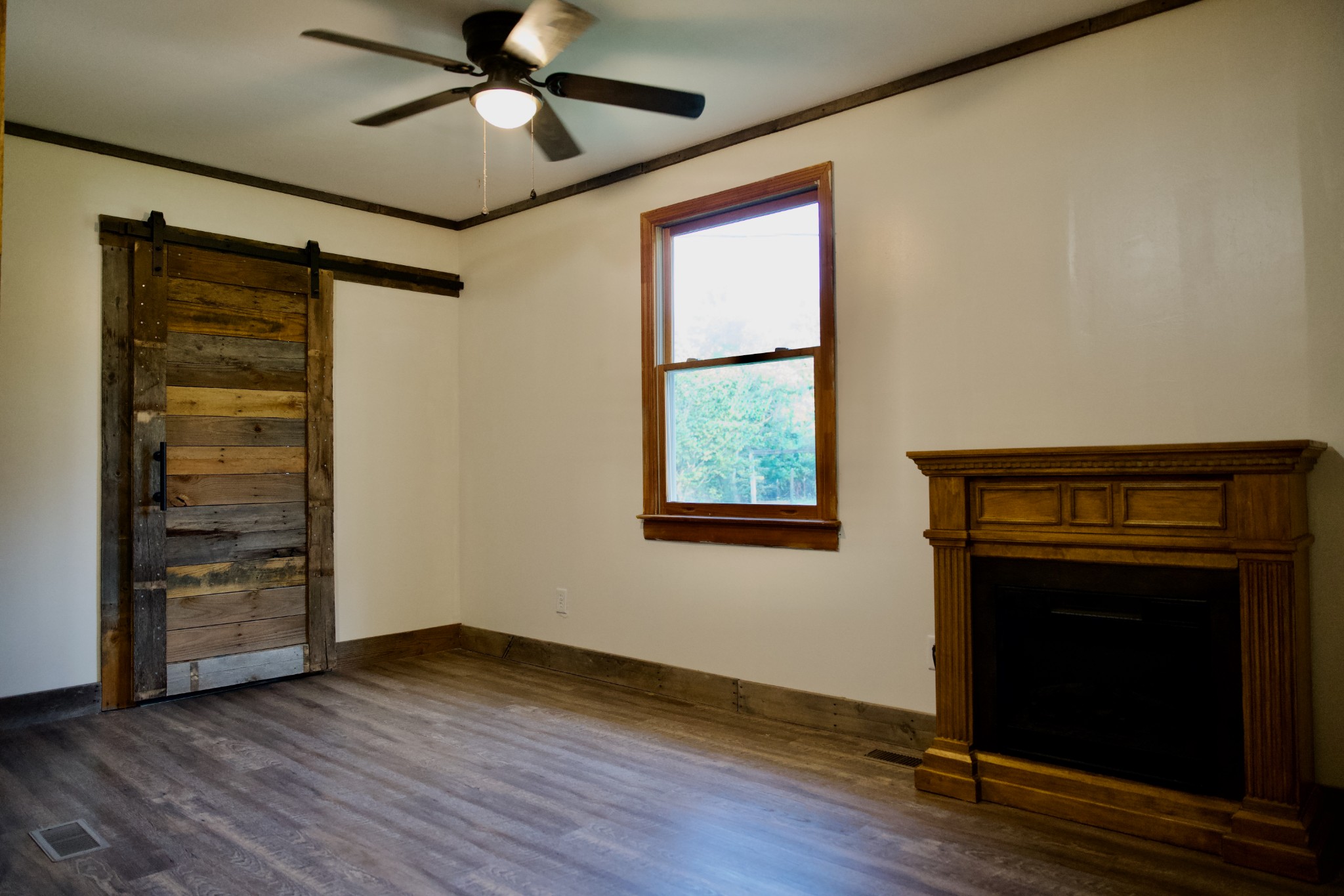 570 Forest Circle Sparta, TN 38583 - Photo 17 of 27 a view of an empty room with a fireplace and a window