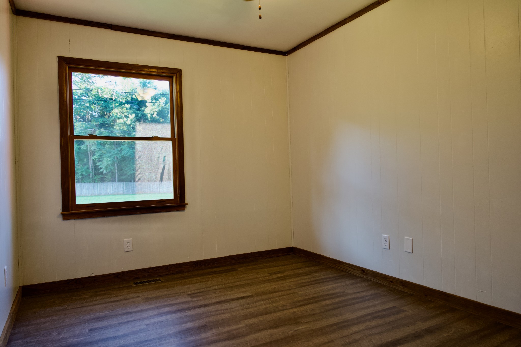 570 Forest Circle Sparta, TN 38583 - Photo 25 of 27 a view of an empty room with wooden floor and a window