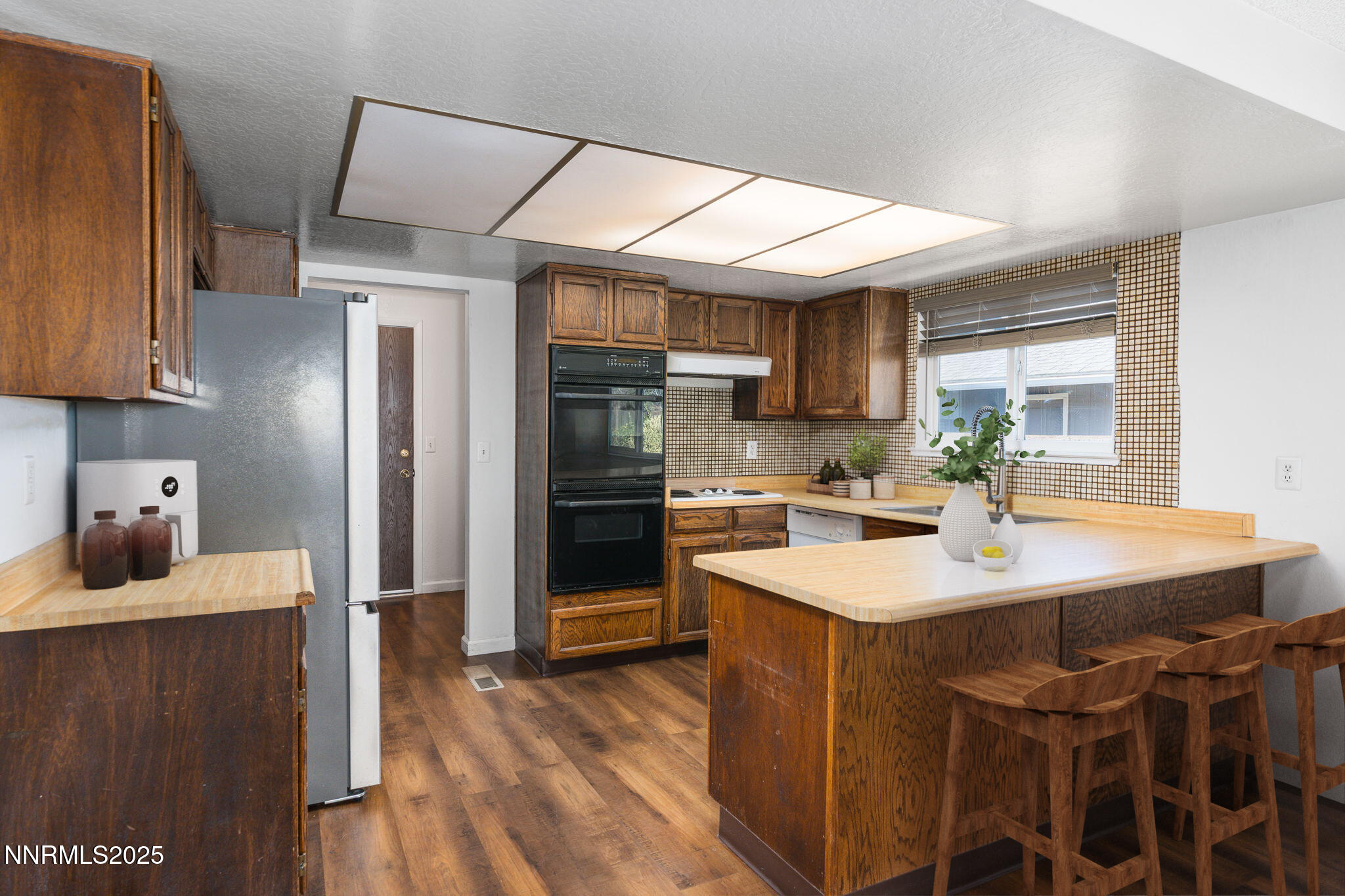 1266 Junction Drive Sparks, NV 89434 - Photo 15 of 32 a kitchen with stainless steel appliances granite countertop a sink stove and refrigerator
