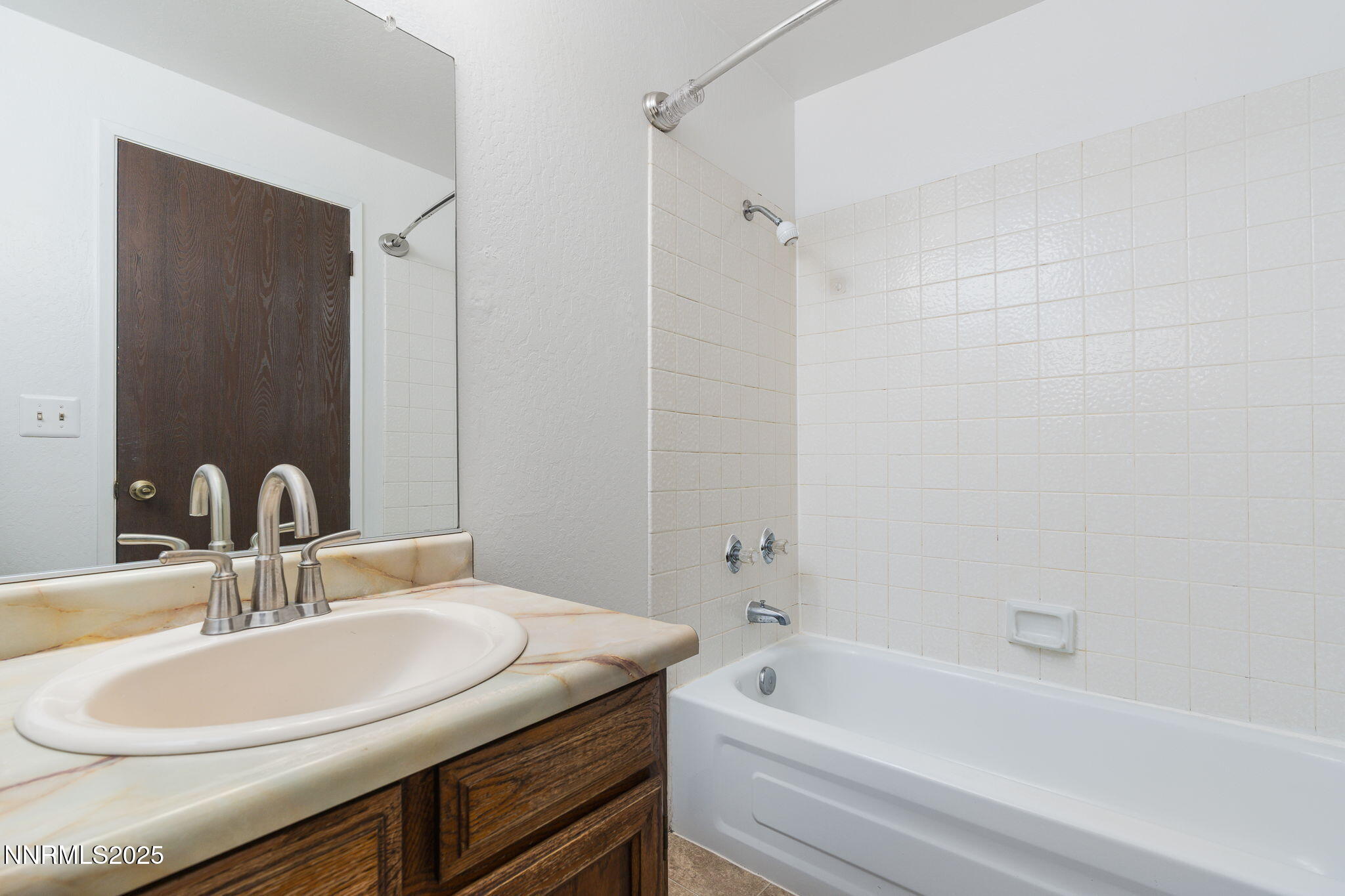 1266 Junction Drive Sparks, NV 89434 - Photo 25 of 32 a bathroom with a granite countertop sink and a mirror