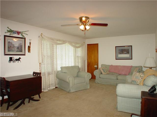 5016 Sitka Road Walkertown, NC 27051 - Photo 3 of 12 Living Room. Neutral carpet, ceiling fan in welcoming living room.