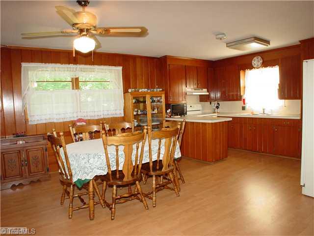 5016 Sitka Road Walkertown, NC 27051 - Photo 4 of 12 Kitchen. Large open kitchen includes smooth surface stove, exhaust fan, dishwasher, refrigerator. Knotty pine cabinets.
