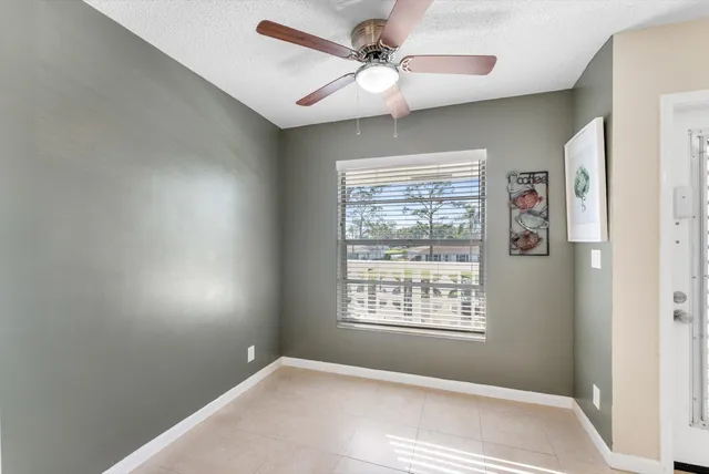 an empty room with a windows and chandelier