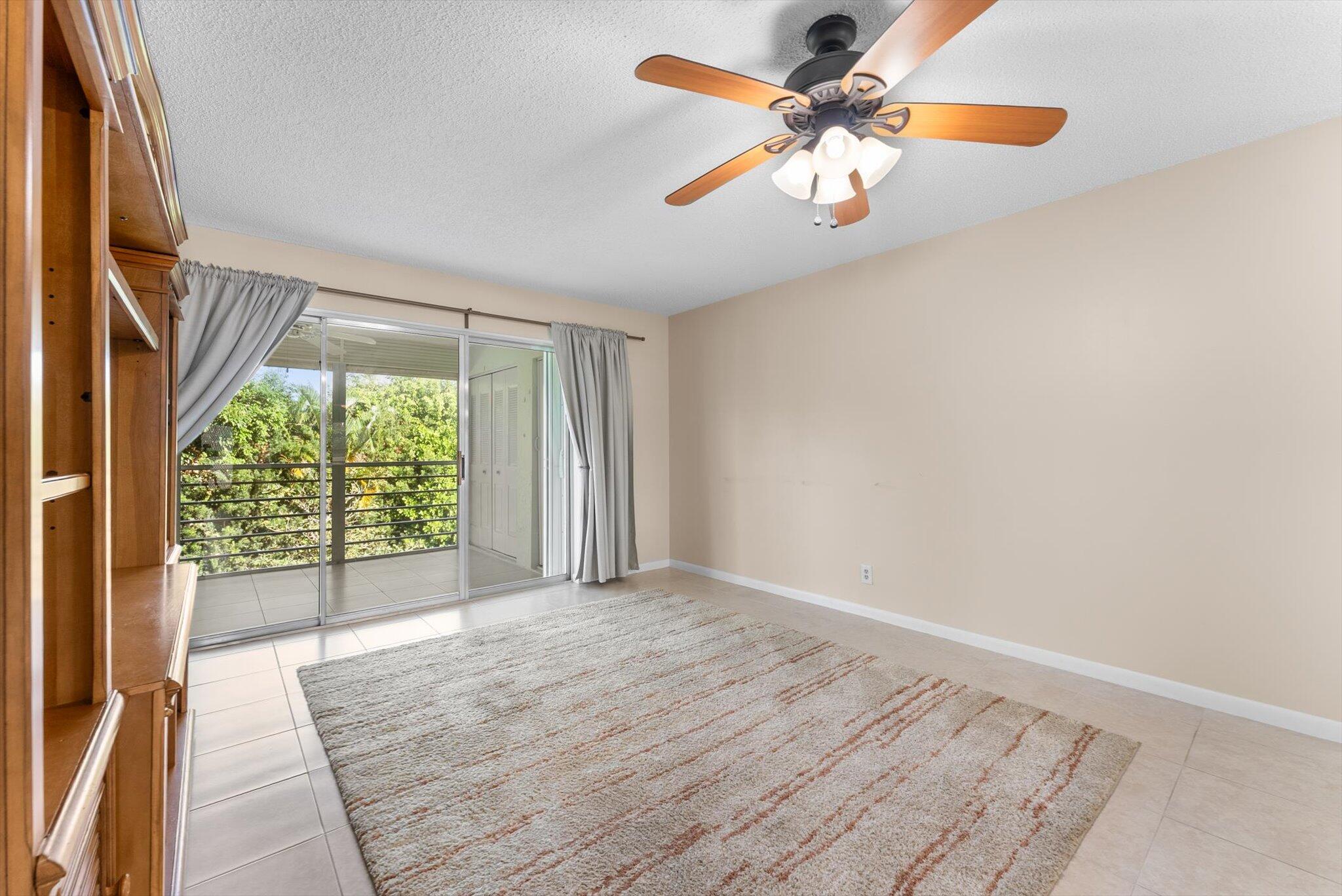 5321 Poppy Place, Unit 203 Delray Beach, FL 33484 - Photo 15 of 31 an empty room with windows and fan