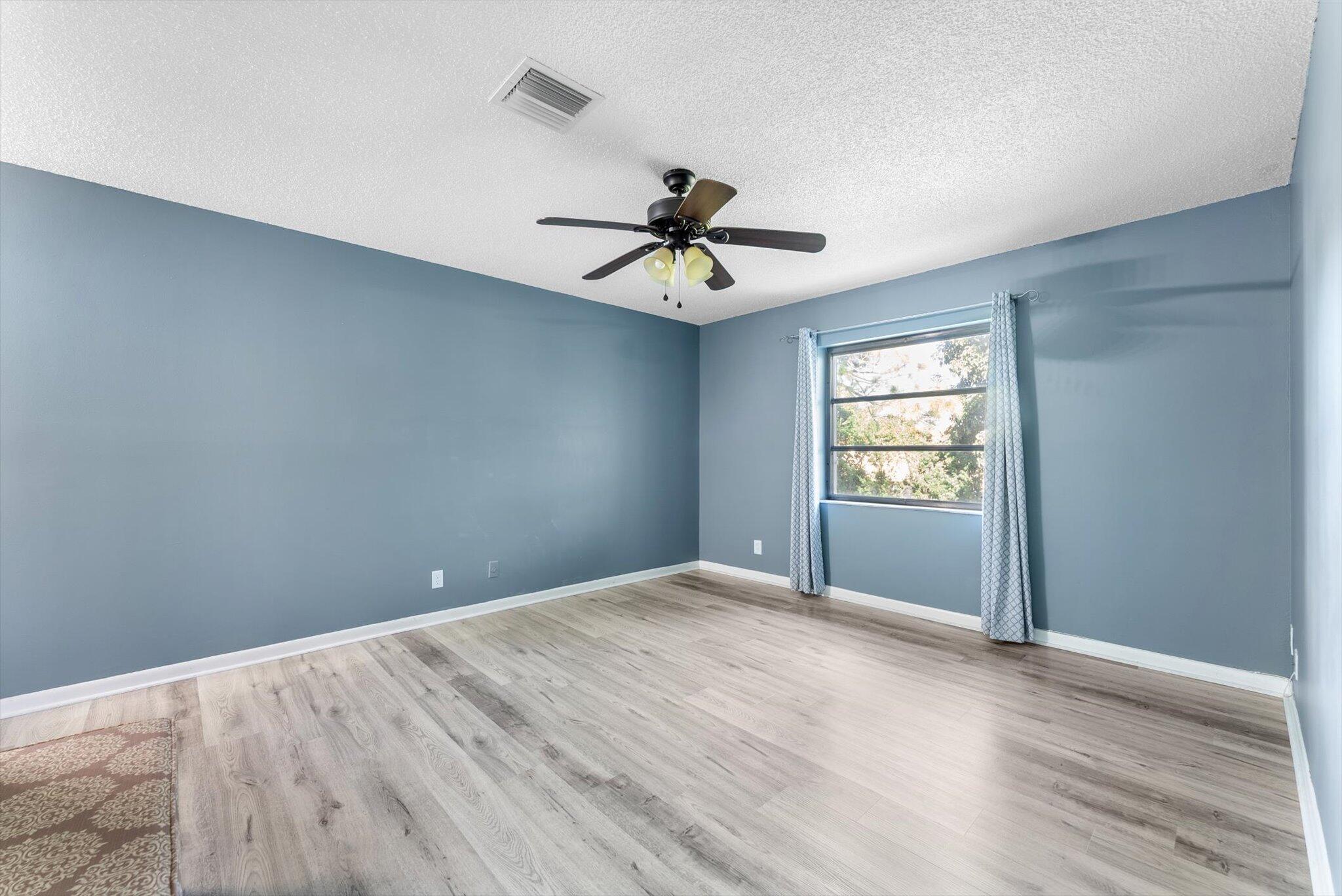 5321 Poppy Place, Unit 203 Delray Beach, FL 33484 - Photo 18 of 31 wooden floor in an empty room with a window