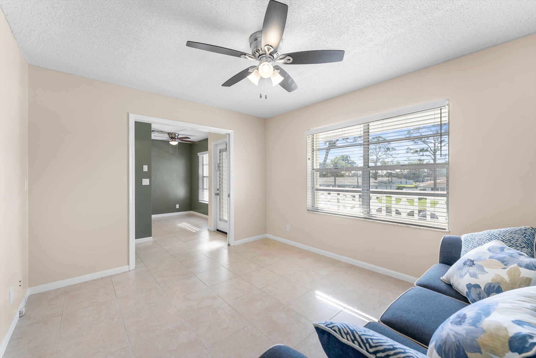 5321 Poppy Place, Unit 203 Delray Beach, FL 33484 - Photo 6 of 31 a living room with furniture and a large window
