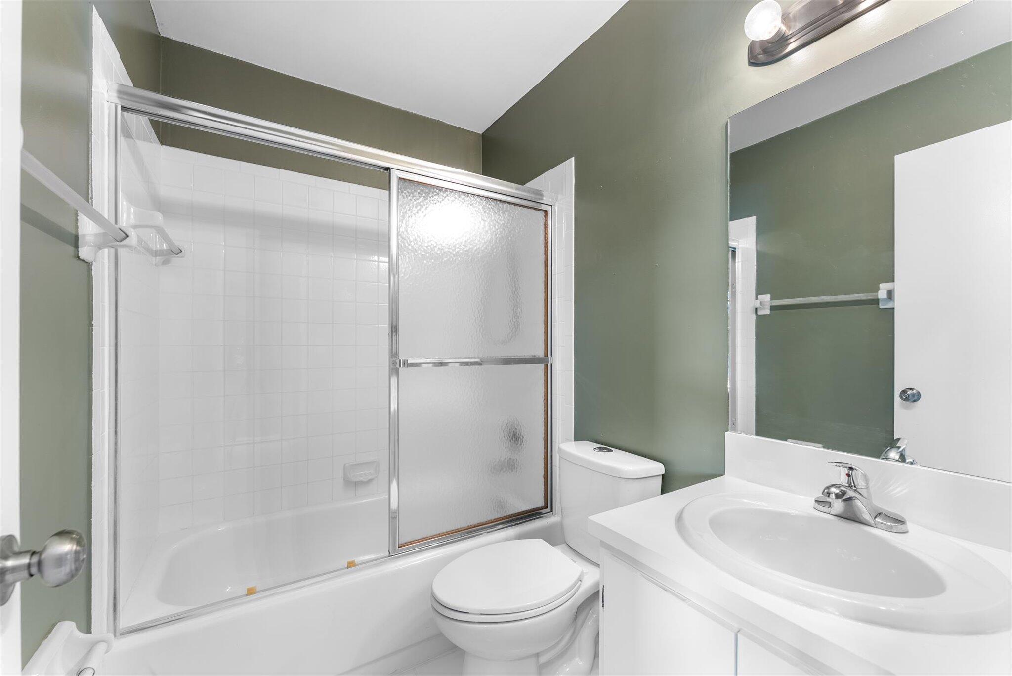 5321 Poppy Place, Unit 203 Delray Beach, FL 33484 - Photo 8 of 31 a bathroom with a sink toilet and shower