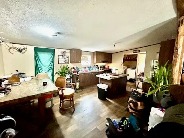 a living room with lots of furniture and kitchen view