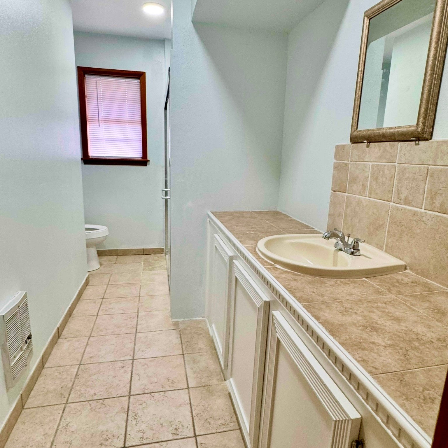 1701 Gillette Street Baytown, TX 77520 - Photo 16 of 21 a bathroom with a sink and a mirror