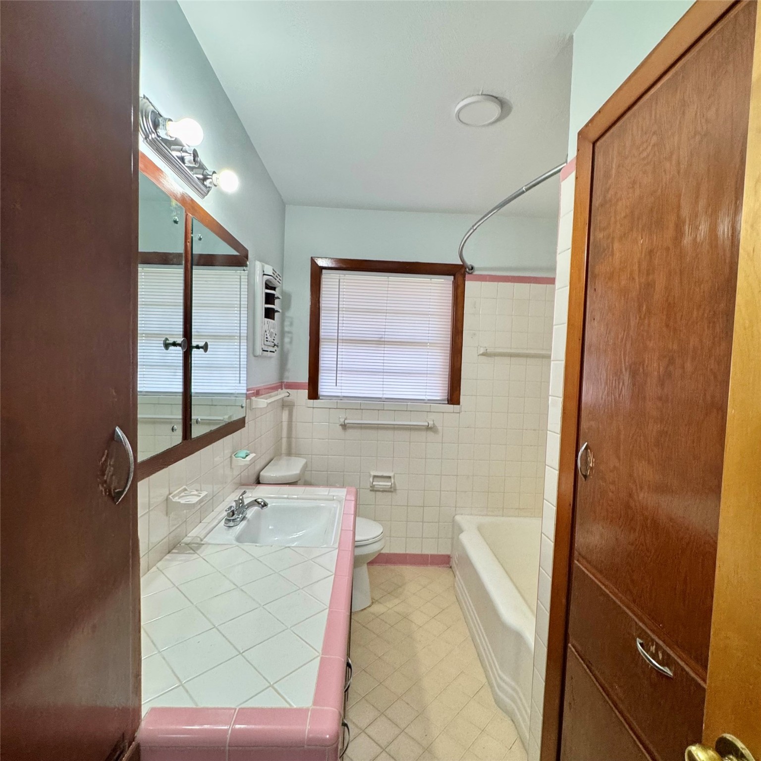 1701 Gillette Street Baytown, TX 77520 - Photo 19 of 21 a bathroom with a sink mirror and a bathtub
