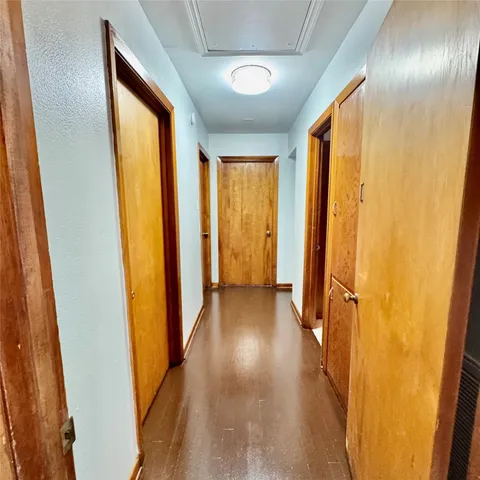 a view of hallway with furniture and a large window