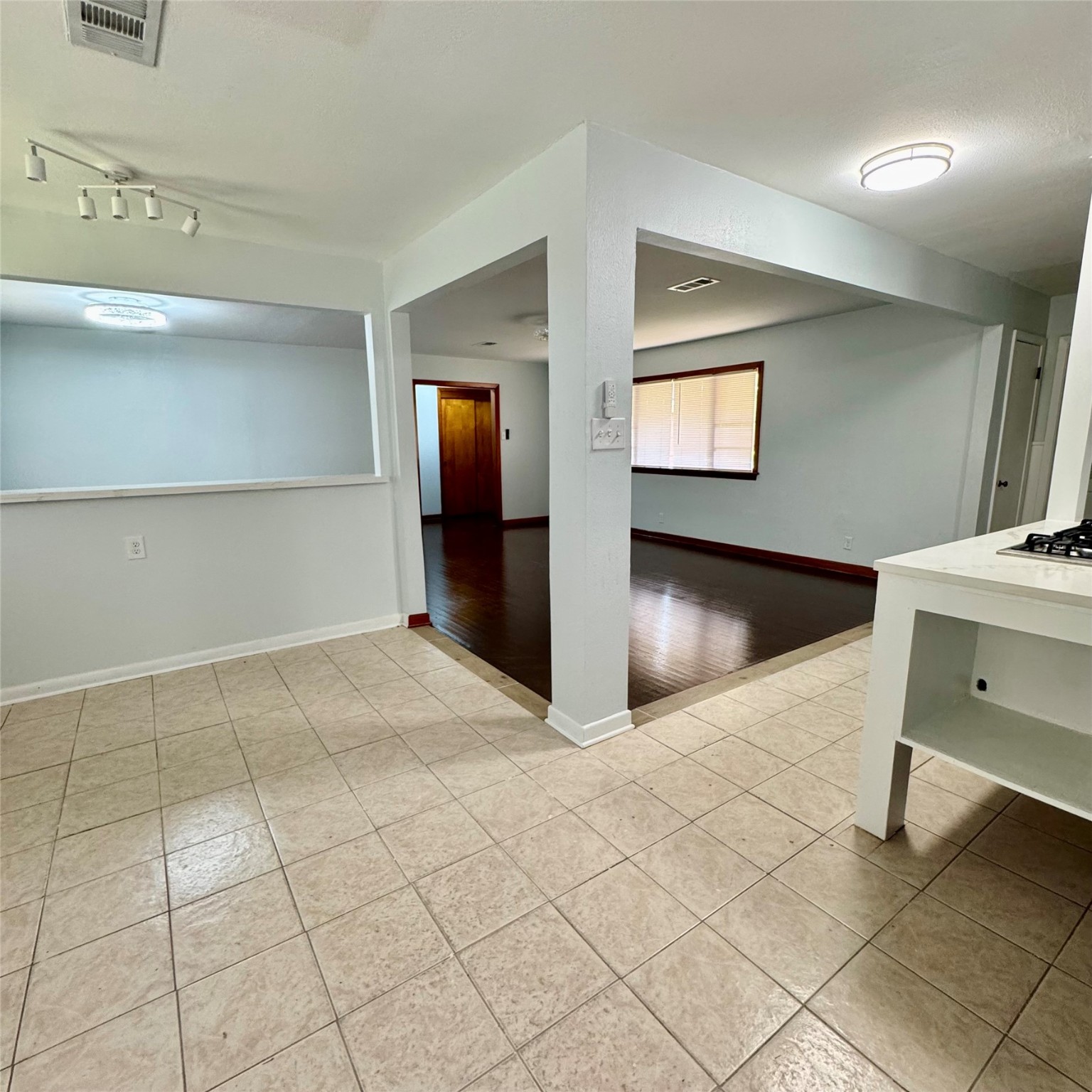 1701 Gillette Street Baytown, TX 77520 - Photo 3 of 21 a view of a hallway to room with wooden floor and furniture
