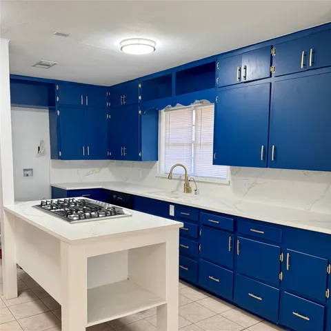 a kitchen with stainless steel appliances granite countertop a sink stove and cabinets