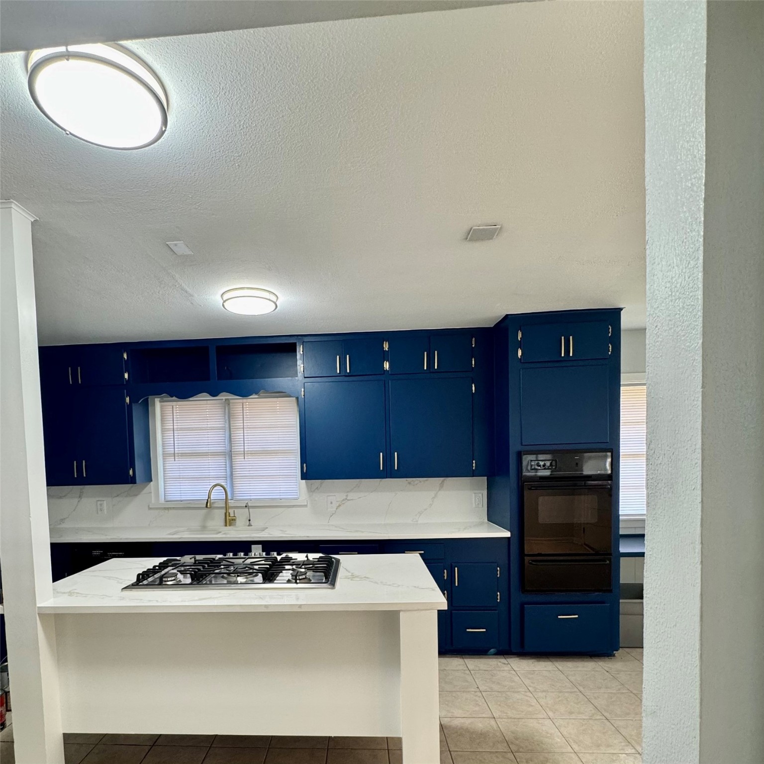 1701 Gillette Street Baytown, TX 77520 - Photo 5 of 21 a kitchen with a sink a stove and cabinets