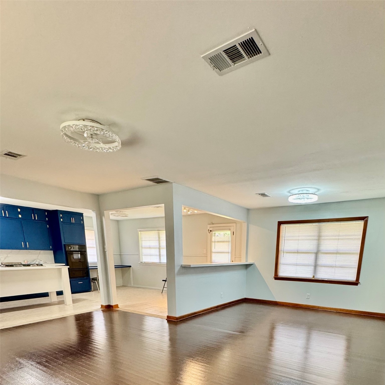 1701 Gillette Street Baytown, TX 77520 - Photo 8 of 21 a view of an empty room with wooden floor and a window