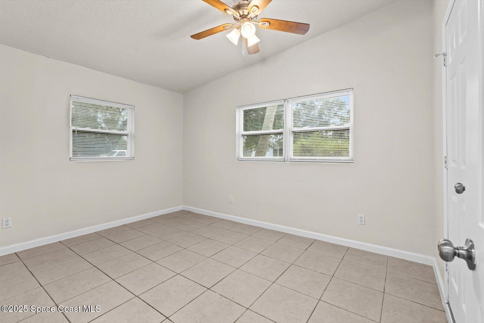7506 Roberts Road Fort Pierce, FL 34951 - Photo 19 of 33 an empty room with windows and fan